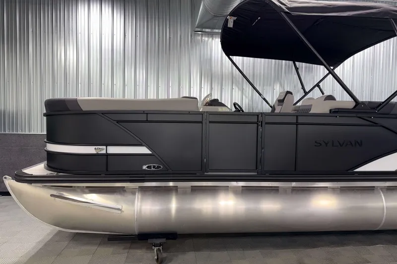Slide: The Image of 2026 Sylvan L3 SLZ pontoon boat with sleek black design in showroom. - 27