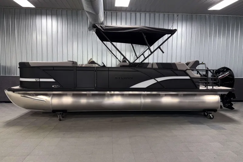 Slide: The Image of 2026 Sylvan L3 SLZ pontoon boat in a showroom with sleek design and canopy. - 28