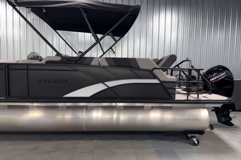 Slide: The Image of 2026 Sylvan L3 SLZ pontoon boat with Mercury outboard motor in showroom. - 29