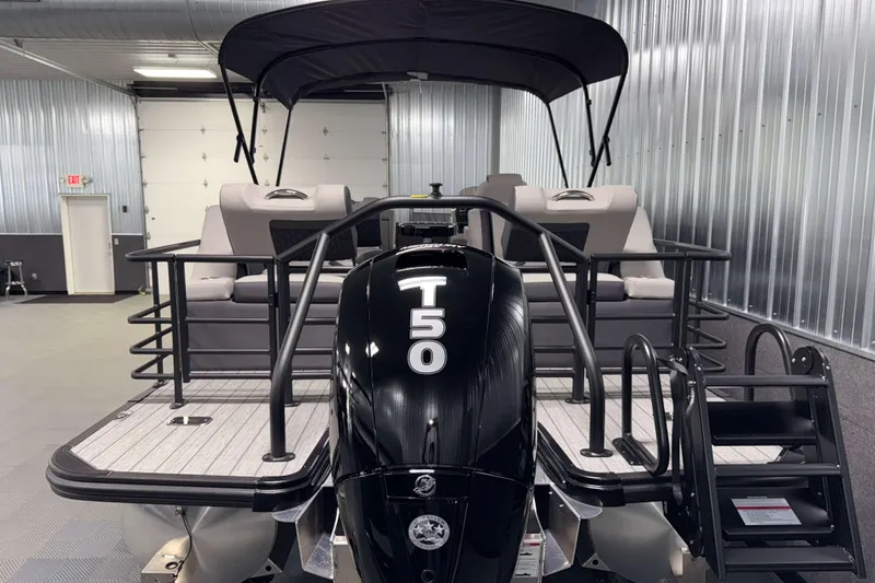 Slide: The Image of 2026 Sylvan L3 SLZ pontoon boat with T50 engine in a metallic garage. - 32