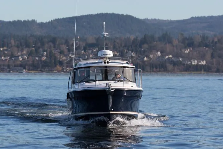 Slide: The Image of Manufacturer Provided Image: 2025 Ranger Tugs R-23 cruising on a scenic lake. - 3
