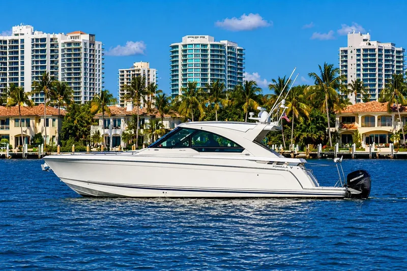 Slide: The Image of 2020 Formula 400 Super Sport Crossover yacht cruising near luxury waterfront homes. - 4