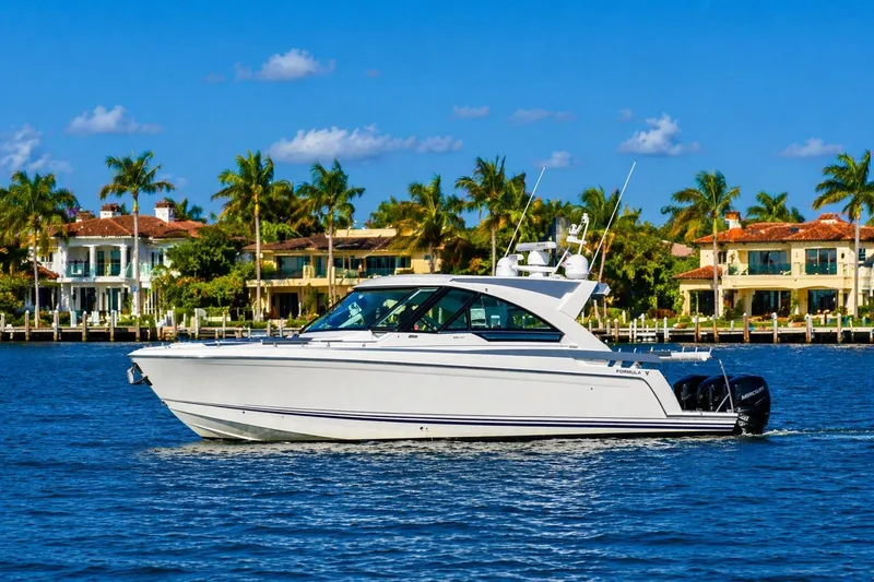 Slide: The Image of 2020 Formula 400 Super Sport Crossover yacht cruising near luxury waterfront homes. - 5