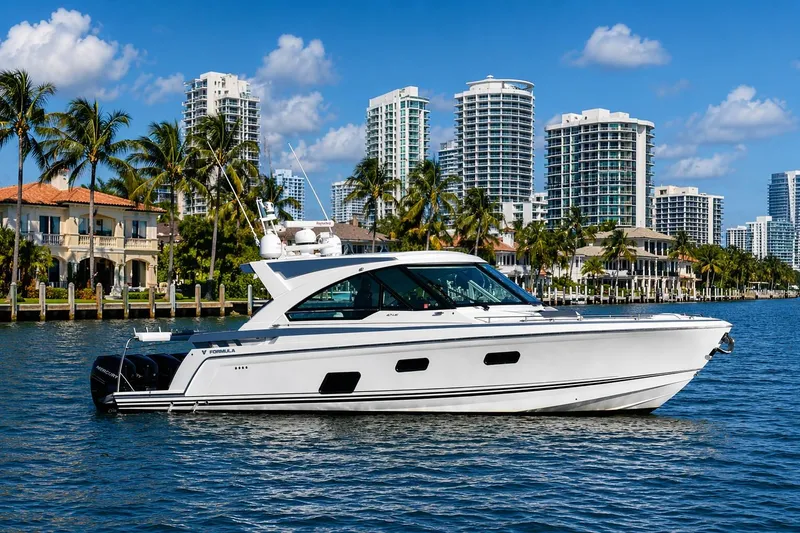 Slide: The Image of 2020 Formula 400 Super Sport Crossover yacht cruising near luxury waterfront homes and skyscrapers. - 7