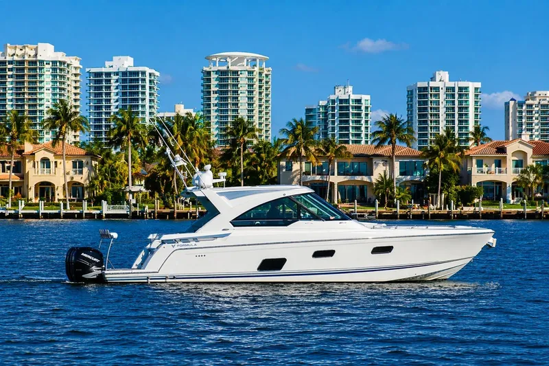 Slide: The Image of 2020 Formula 400 Super Sport Crossover yacht cruising near luxury waterfront homes and skyscrapers. - 8