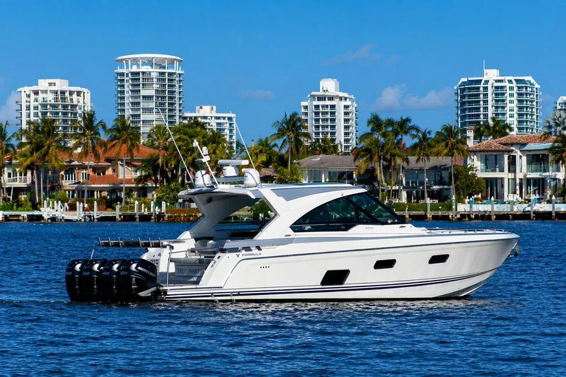 Slide: The Image of 2020 Formula 400 Super Sport Crossover yacht cruising near luxury waterfront homes. - 9
