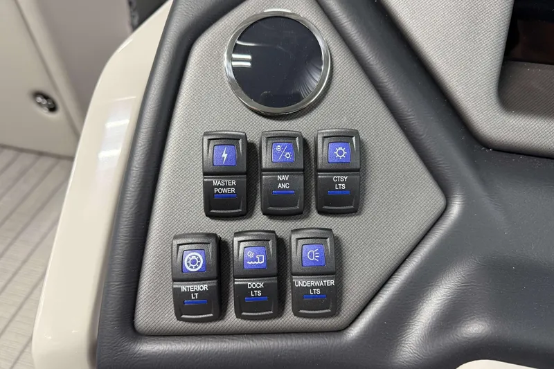 Slide: The Image of Control panel of 2026 Sylvan L3 SLZ boat with various function switches. - 12