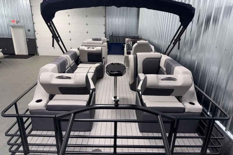 Slide: The Image of 2026 Sylvan L3 SLZ pontoon boat with luxurious seating in a showroom. - 25