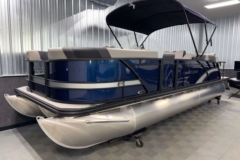 Slide: The Image of 2026 Sylvan L3 SLZ pontoon boat with blue exterior in a showroom. - 26