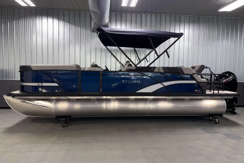Slide: The Image of 2026 Sylvan L3 SLZ pontoon boat with blue exterior and canopy in showroom. - 30