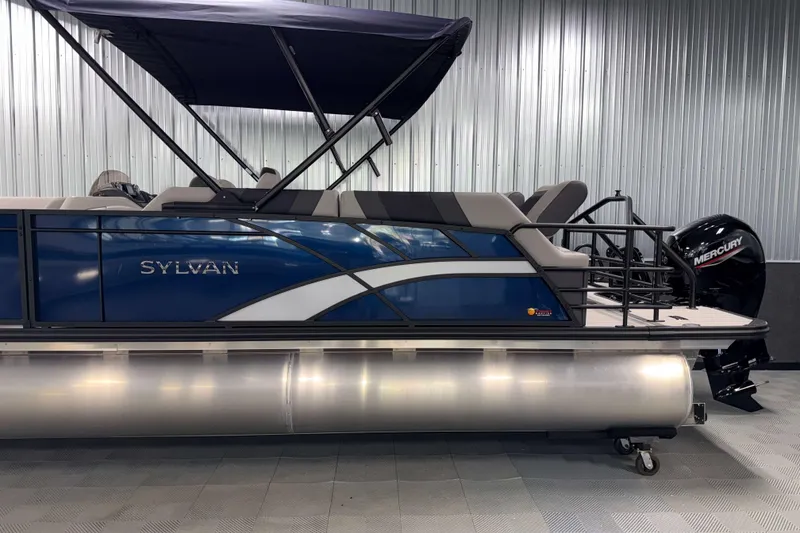 Slide: The Image of 2026 Sylvan L3 SLZ pontoon boat with Mercury outboard motor in showroom. - 31