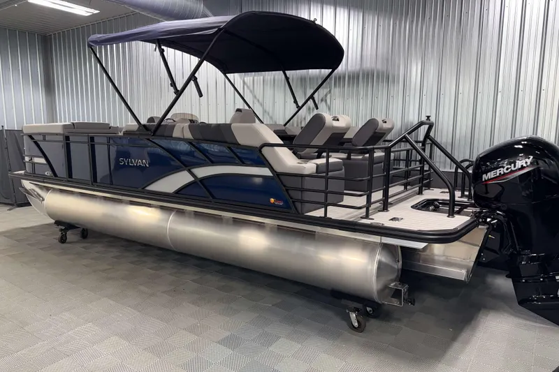 Slide: The Image of 2026 Sylvan L3 SLZ pontoon boat with Mercury engine in a showroom. - 32