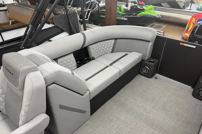 Slide: The Image of 2026 Crest Conquest 215 SLC boat interior with gray seating and modern design. - 11