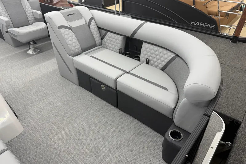 Slide: The Image of 2026 Crest Conquest 215 SLC boat interior with luxurious gray seating and cup holders. - 2