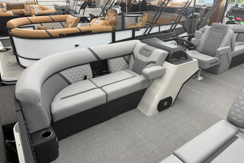 Slide: The Image of 2026 Crest Conquest 215 SLC pontoon boat interior with luxurious seating and modern design. - 3