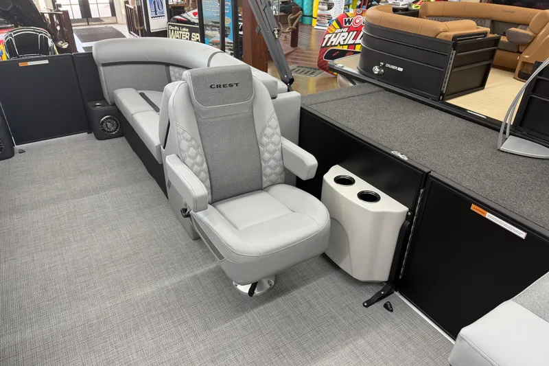 Slide: The Image of 2026 Crest Conquest 215 SLC boat interior with gray seating and cup holders. - 4