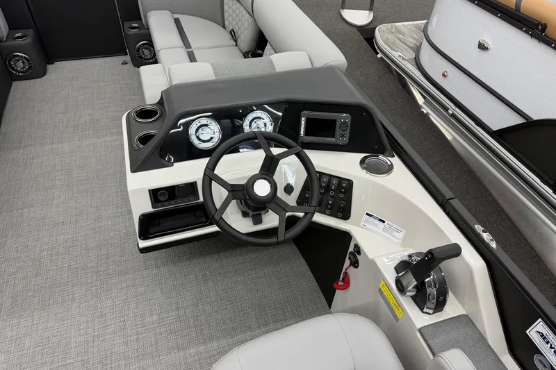 Slide: The Image of 2026 Crest Conquest 215 SLC boat dashboard with steering wheel and controls. - 6