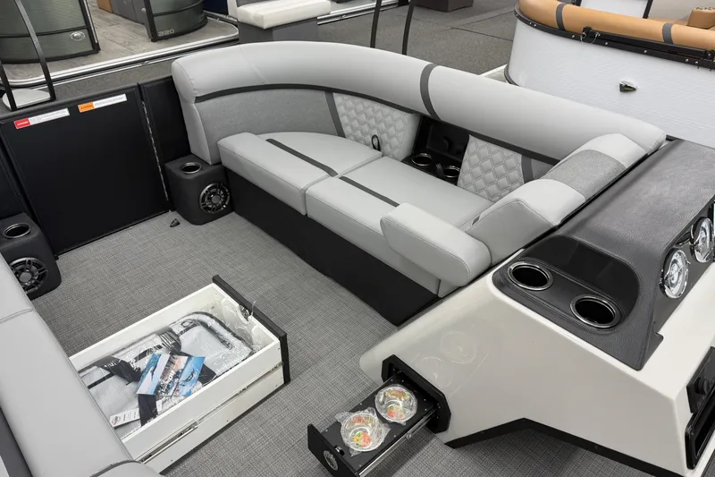Slide: The Image of 2026 Crest Conquest 215 SLC boat interior with gray seating and storage compartments. - 7