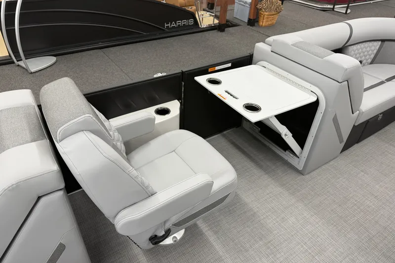 Slide: The Image of 2026 Crest Conquest 215 SLC boat interior with gray seating and foldable table. - 9