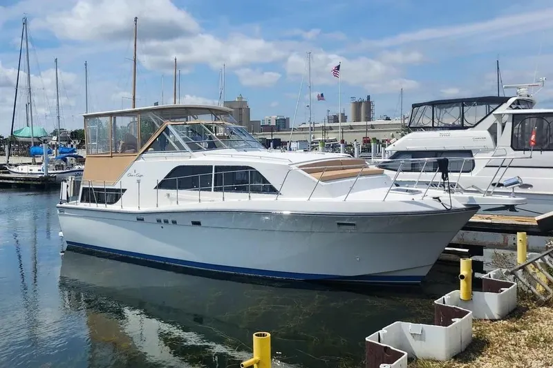 The Image of 1989 Chris-Craft 381 Catalina yacht docked at a marina under a blue sky. - 1