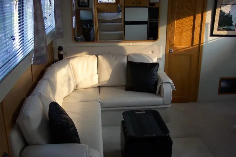 Slide: The Image of Interior of 1989 Chris-Craft 381 Catalina yacht with white sofa and black cushions. - 11