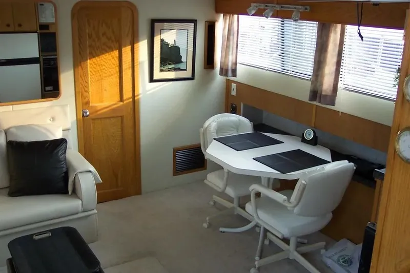 Slide: The Image of Interior of 1989 Chris-Craft 381 Catalina yacht with dining area and seating. - 12