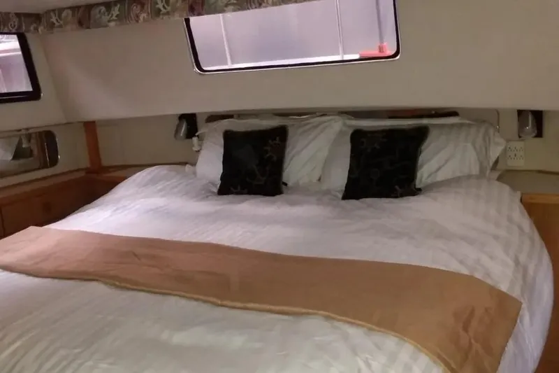 Slide: The Image of Interior cabin of 1989 Chris-Craft 381 Catalina with cozy bed and pillows. - 17