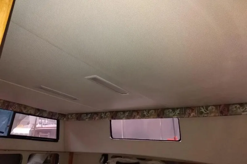Slide: The Image of Interior ceiling of 1989 Chris-Craft 381 Catalina boat with floral trim and windows. - 18