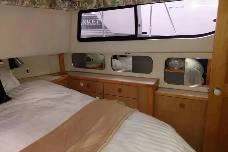 Slide: The Image of 1989 Chris-Craft 381 Catalina yacht interior with cozy bedroom and wooden cabinetry. - 20
