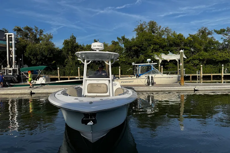Slide: The Image of 2021 Sportsman Open 242 Center Console boat docked at marina. - 12
