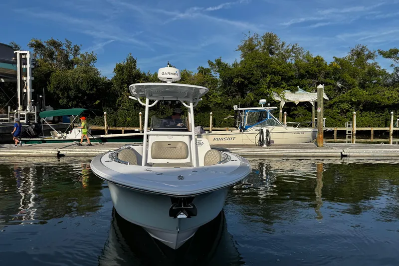 Slide: The Image of 2021 Sportsman Open 242 Center Console boat docked in a marina. - 13