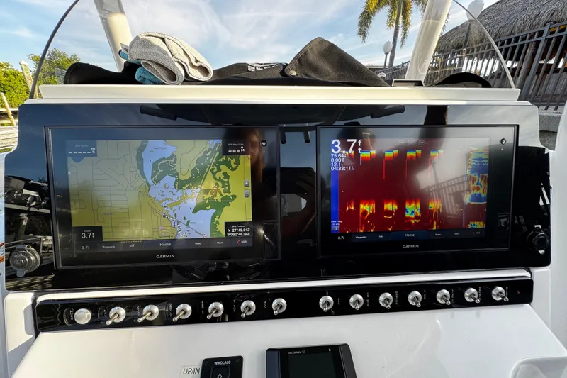 Slide: The Image of 2021 Sportsman Open 242 Center Console with dual Garmin displays showing navigation and sonar data. - 24