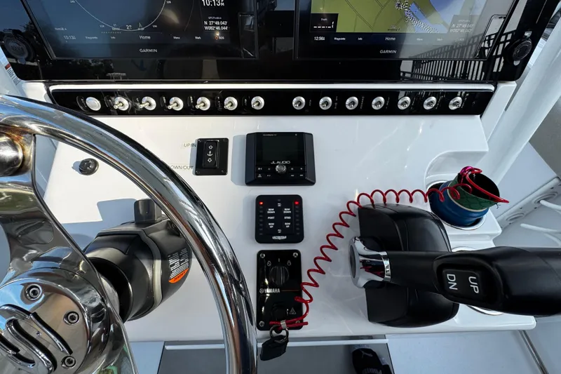 Slide: The Image of 2021 Sportsman Open 242 Center Console dashboard with steering wheel and navigation controls. - 25
