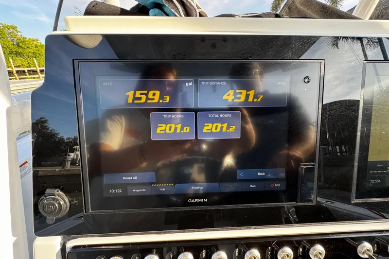 Slide: The Image of 2021 Sportsman Open 242 Center Console dashboard displaying fuel usage and trip data. - 26