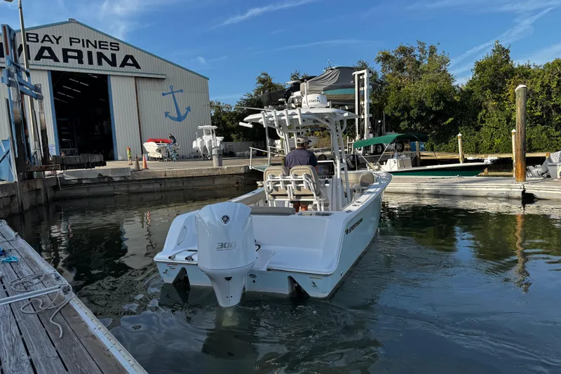 Slide: The Image of 2021 Sportsman Open 242 Center Console boat at Bay Pines Marina dock. - 3