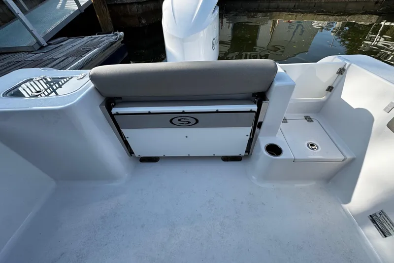 Slide: The Image of 2021 Sportsman Open 242 Center Console boat interior with seating and storage. - 31
