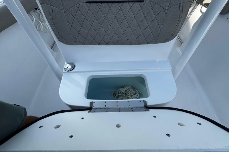Slide: The Image of 2021 Sportsman Open 242 Center Console boat with storage compartment and rope. - 34