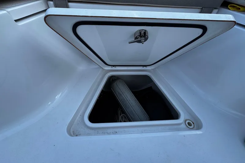 Slide: The Image of Open storage compartment on 2021 Sportsman Open 242 Center Console boat. - 35