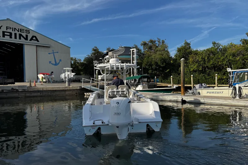 Slide: The Image of 2021 Sportsman Open 242 Center Console boat at marina dock. - 6