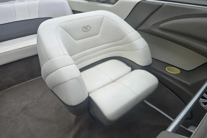 Slide: The Image of White leather seat in a 2001 Cobalt 232 boat interior. - 10