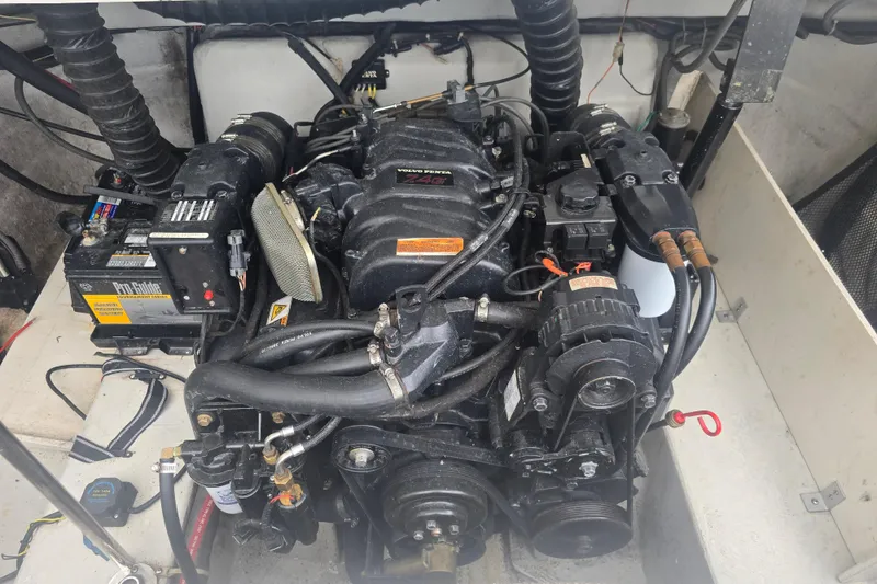 Slide: The Image of Engine compartment of a 2001 Cobalt 232 boat, featuring a Volvo Penta engine. - 16