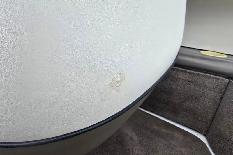 Slide: The Image of Damaged upholstery on 2001 Cobalt 232 boat interior, showing wear and tear. - 19