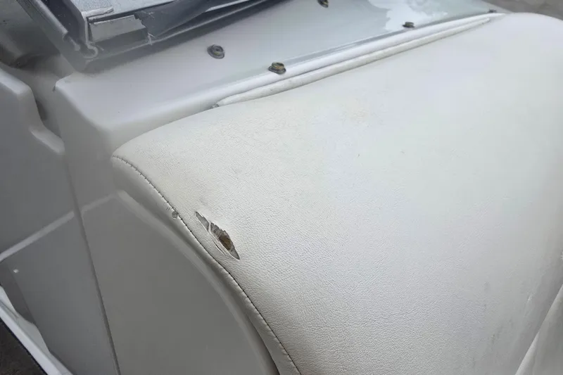 Slide: The Image of Torn white upholstery on 2001 Cobalt 232 boat seat. - 20