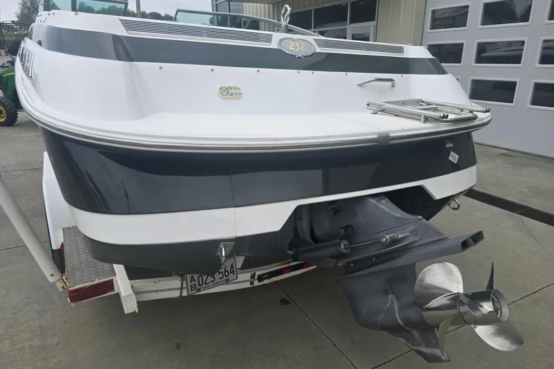 Slide: The Image of 2001 Cobalt 232 boat on trailer, rear view showing propeller and hull design. - 3