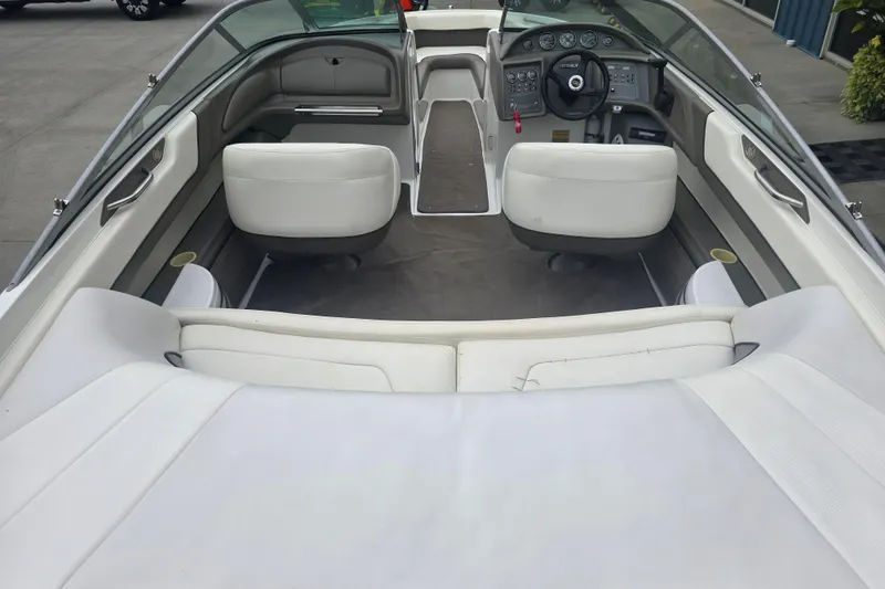 Slide: The Image of Interior of a 2001 Cobalt 232 boat with white seating and dashboard. - 4