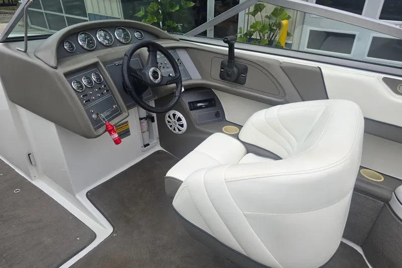 Slide: The Image of Interior of a 2001 Cobalt 232 boat with white seating and control panel. - 6