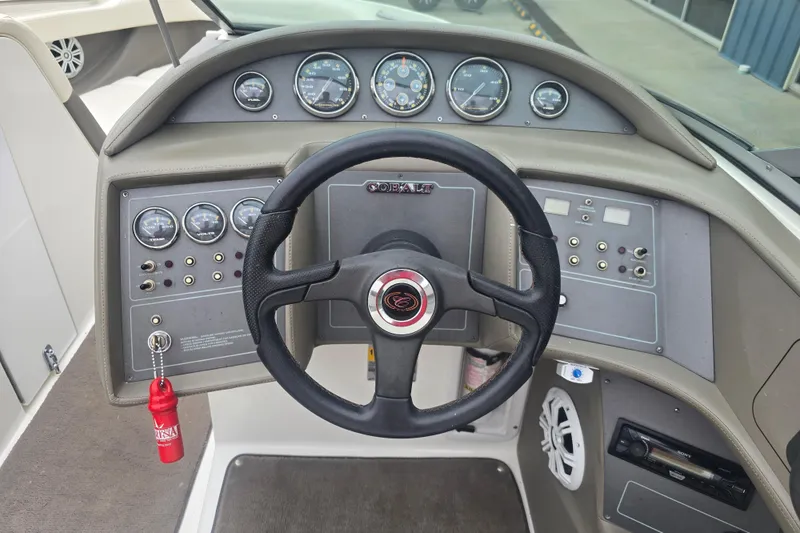 Slide: The Image of Steering console of a 2001 Cobalt 232 boat with gauges and controls. - 7