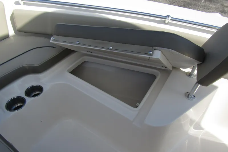 Slide: The Image of 2022 Key West 219 FS boat interior with storage compartment and cup holders. - 10