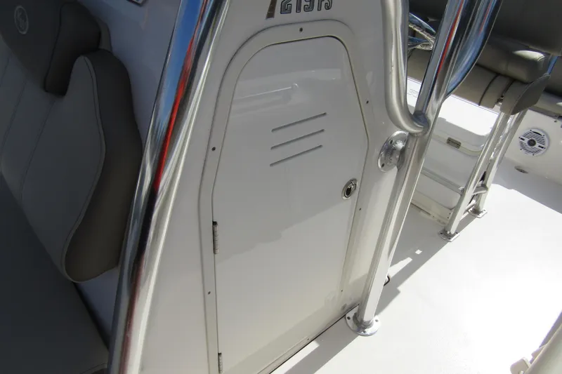 Slide: The Image of 2022 Key West 219 FS boat interior with sleek seating and storage compartment. - 14