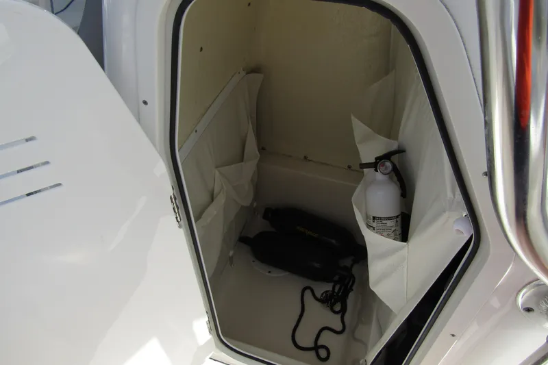 Slide: The Image of Storage compartment in 2022 Key West 219 FS boat with fire extinguisher and equipment. - 15